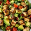 A delicious Avocado Chicken Salad with fresh ingredients and garnishes.