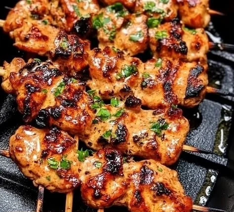 Bang Bang Chicken Skewers served on a platter with dipping sauce