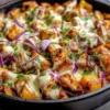 BBQ chicken sweet potato skillet topped with fresh herbs and spices