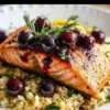Blueberry Glazed Salmon served with Lemon Herb Couscous on a plate.