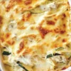 Delicious Chicken Alfredo Zucchini Lasagna topped with creamy sauce and cheese.