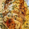 Creamy Parmesan Baked Caesar Chicken with crispy toppings and fresh herbs