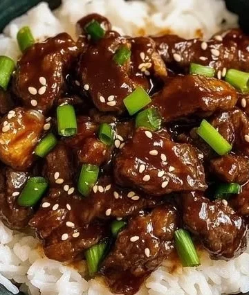 Crock Pot Korean Beef dish garnished with green onions and served with rice