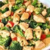 Plate of Garlic Chicken with Broccoli and Spinach garnished with herbs