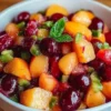 Healthy peach cherry salsa served in a bowl with fresh ingredients.