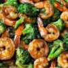 Honey Garlic Butter Shrimp served with fresh broccoli in a savory sauce.