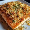 Irresistibly crispy Parmesan Salmon Bake dish with fresh herbs and side vegetables