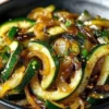 Delicious Japanese Zucchini and Onion Stir-Fry served in a bowl