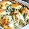 Creamy Spinach Artichoke Chicken Bake topped with cheese and herbs