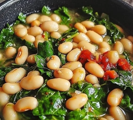 Spinach and white beans power bowl topped with fresh vegetables