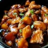 Sweet Hawaiian Crockpot Chicken served in a bowl with tropical garnishes