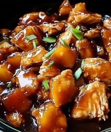 Sweet Hawaiian Crockpot Chicken served in a bowl with tropical garnishes