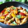 Delicious plate of Thai Peach Chicken with juicy peaches and spices