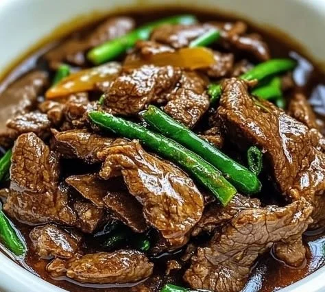 Slow cooker Mongolian beef served with rice and vegetables.