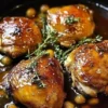 Succulent baked chicken thighs served with herbs and spices