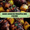Baked Jamaican Pineapple Jerk Chicken on a plate with fresh herbs
