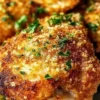 Crispy Parmesan chicken thighs served with herbs and vegetables