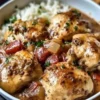 Italian crockpot chicken thighs dish garnished with herbs in a slow cooker