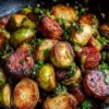 Kielbasa and Brussels sprouts stir-fry in a skillet, colorful and appetizing.