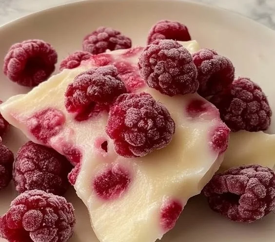 Raspberry Yogurt Bites served in a bowl with fresh raspberries