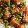 Bowl of Slow Cooker Asian Sesame Chicken with sesame seeds and green onions