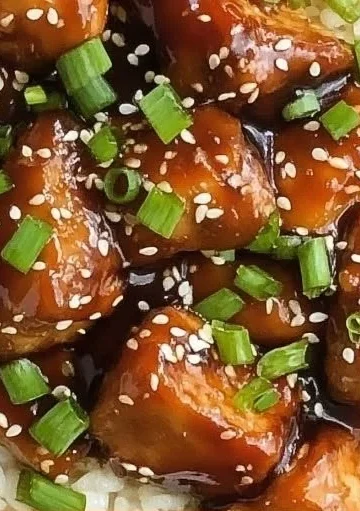 Bowl of Slow Cooker Asian Sesame Chicken with sesame seeds and green onions