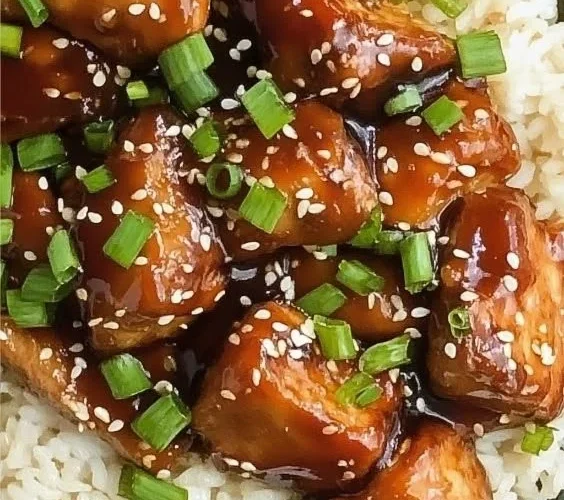 Bowl of Slow Cooker Asian Sesame Chicken with sesame seeds and green onions