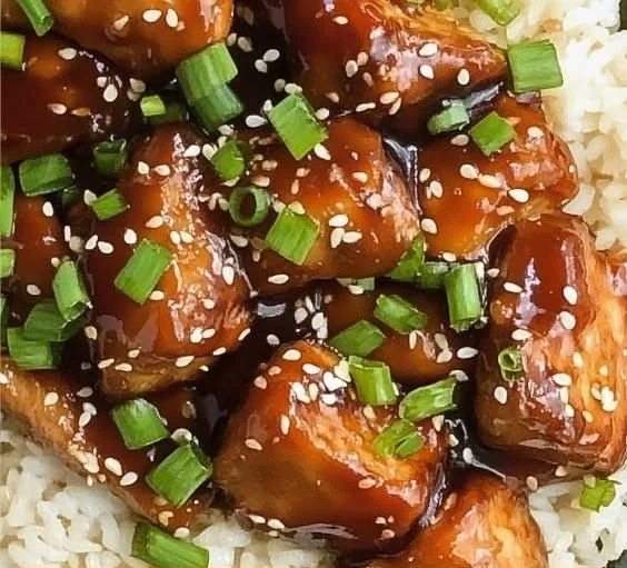 Bowl of Slow Cooker Asian Sesame Chicken with sesame seeds and green onions