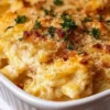 Bowl of creamy spaghetti squash mac and cheese topped with herbs and cheese