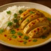 Spicy Brazilian Coconut Chicken served with fresh herbs and vibrant sides
