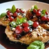 Plate of Strawberry Basil Chicken garnished with fresh basil and strawberries