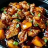 Delicious Sweet Hawaiian Crockpot Chicken served in a bowl with pineapple and sauce