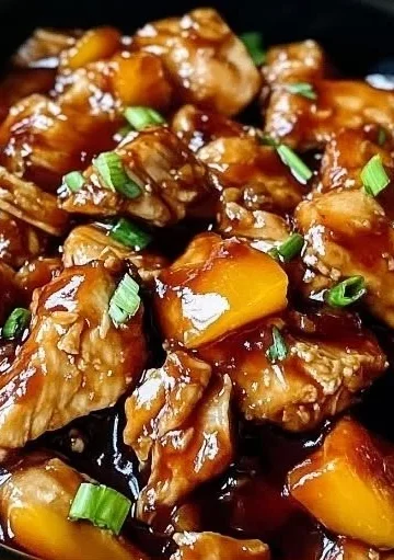 Delicious Sweet Hawaiian Crockpot Chicken served in a bowl with pineapple and sauce