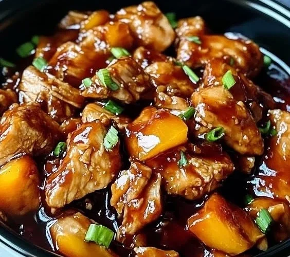 Delicious Sweet Hawaiian Crockpot Chicken served in a bowl with pineapple and sauce