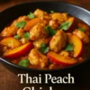 A delicious serving of Thai Peach Chicken garnished with fresh herbs.