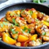 Delicious Thai Peach Chicken garnished with fresh herbs and peaches